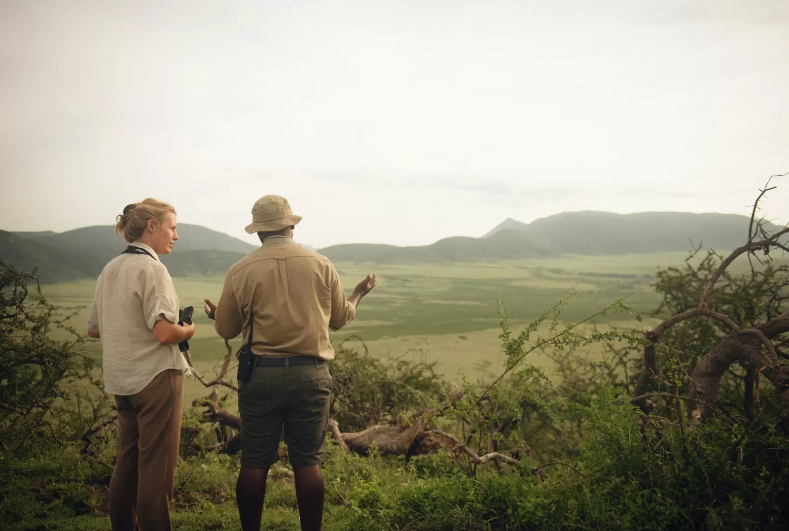 Guest listening to a Nomad guide explain about the wildlife they are looking for